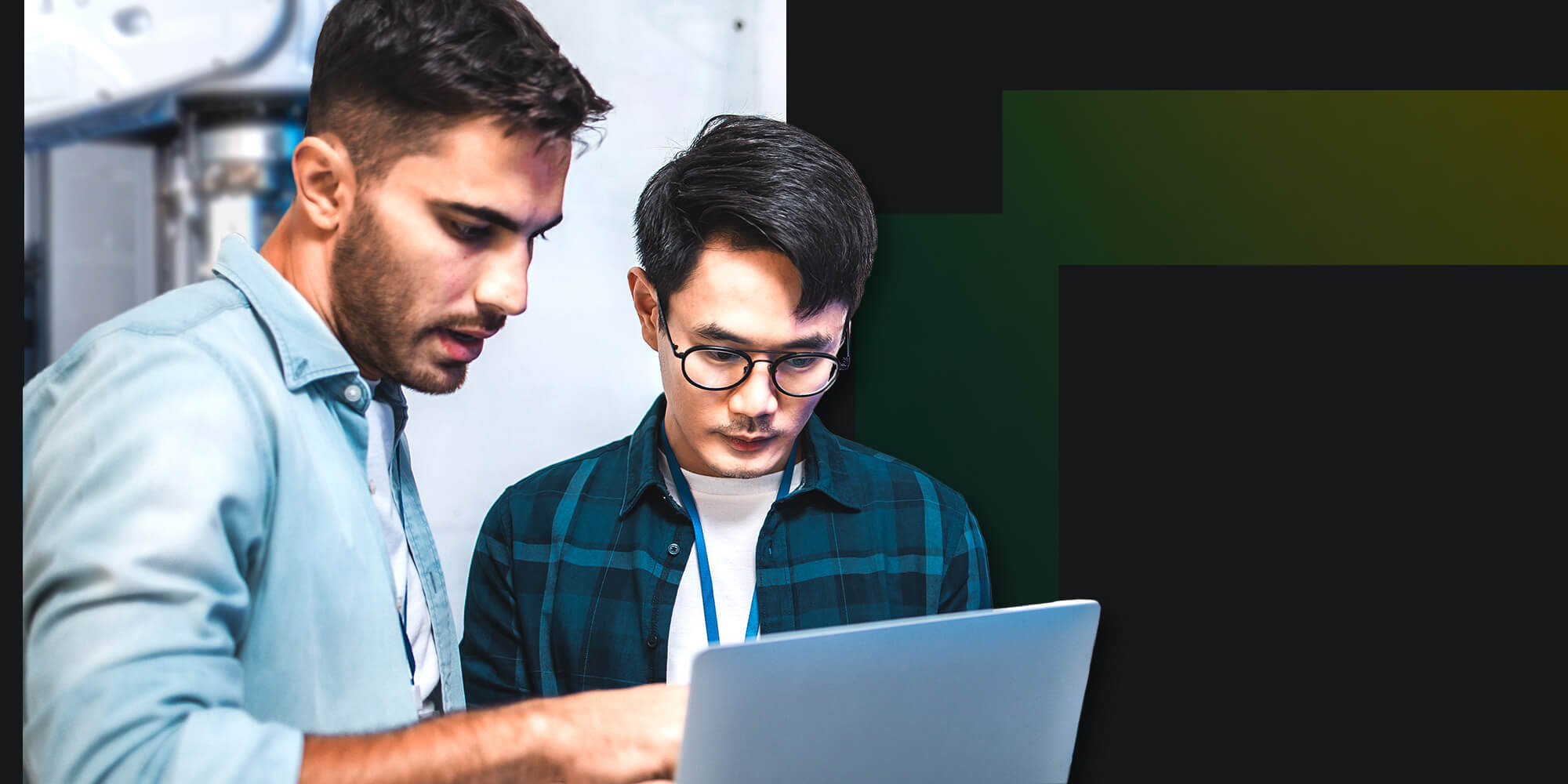 Two tech leaders discuss information displayed on a laptop