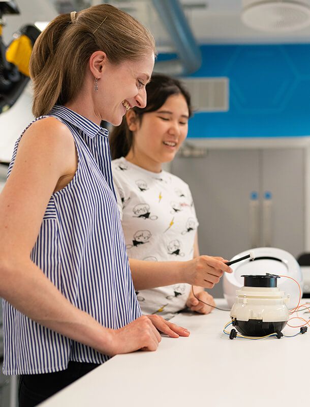 Two women test a new tech device
