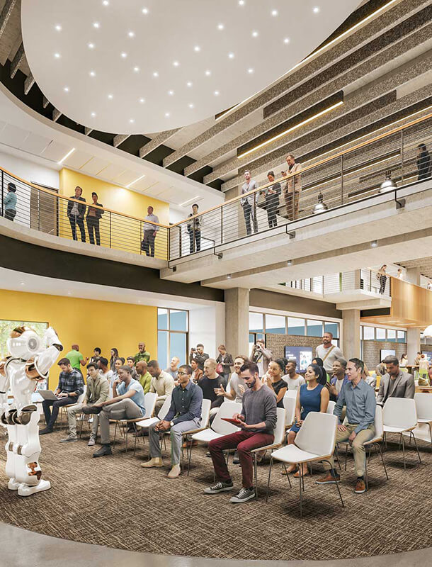 A human-sized robot delivers a lecture in a two-story gathering hall at Fuse at Mason Square